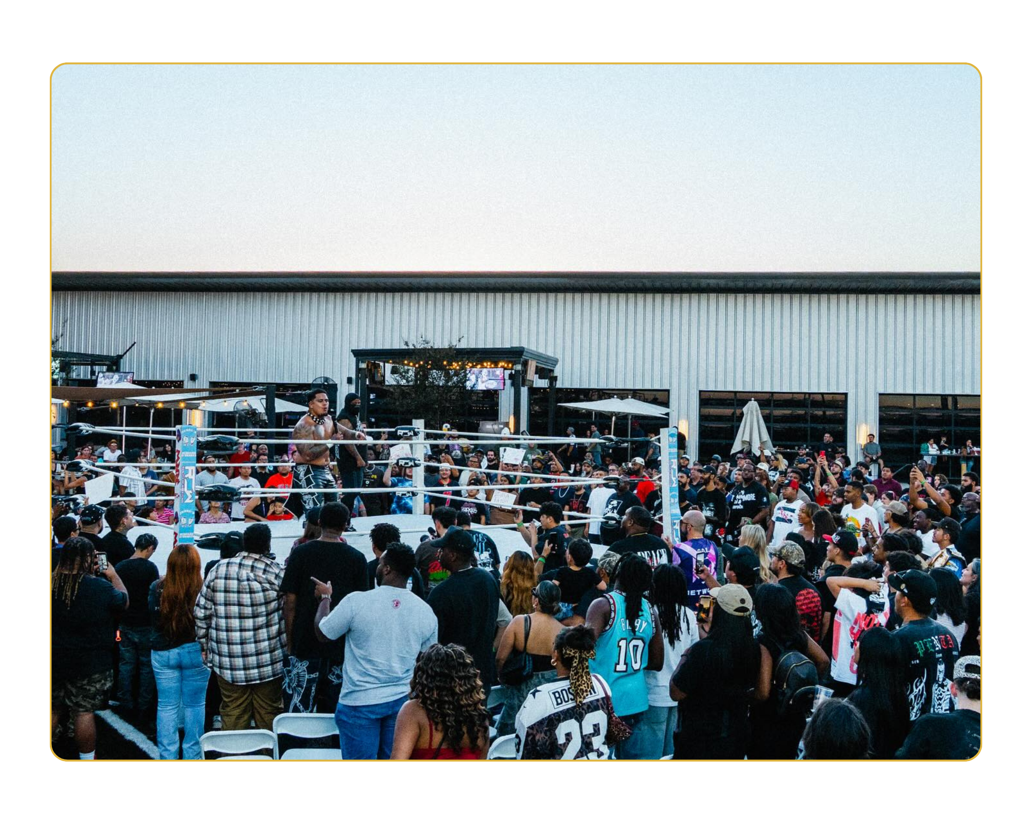 zilla fatu in ring with maxo. Photo taken from far away showing the crowd